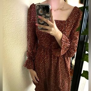 A dark beautiful red with little flowers scattered across the dress!